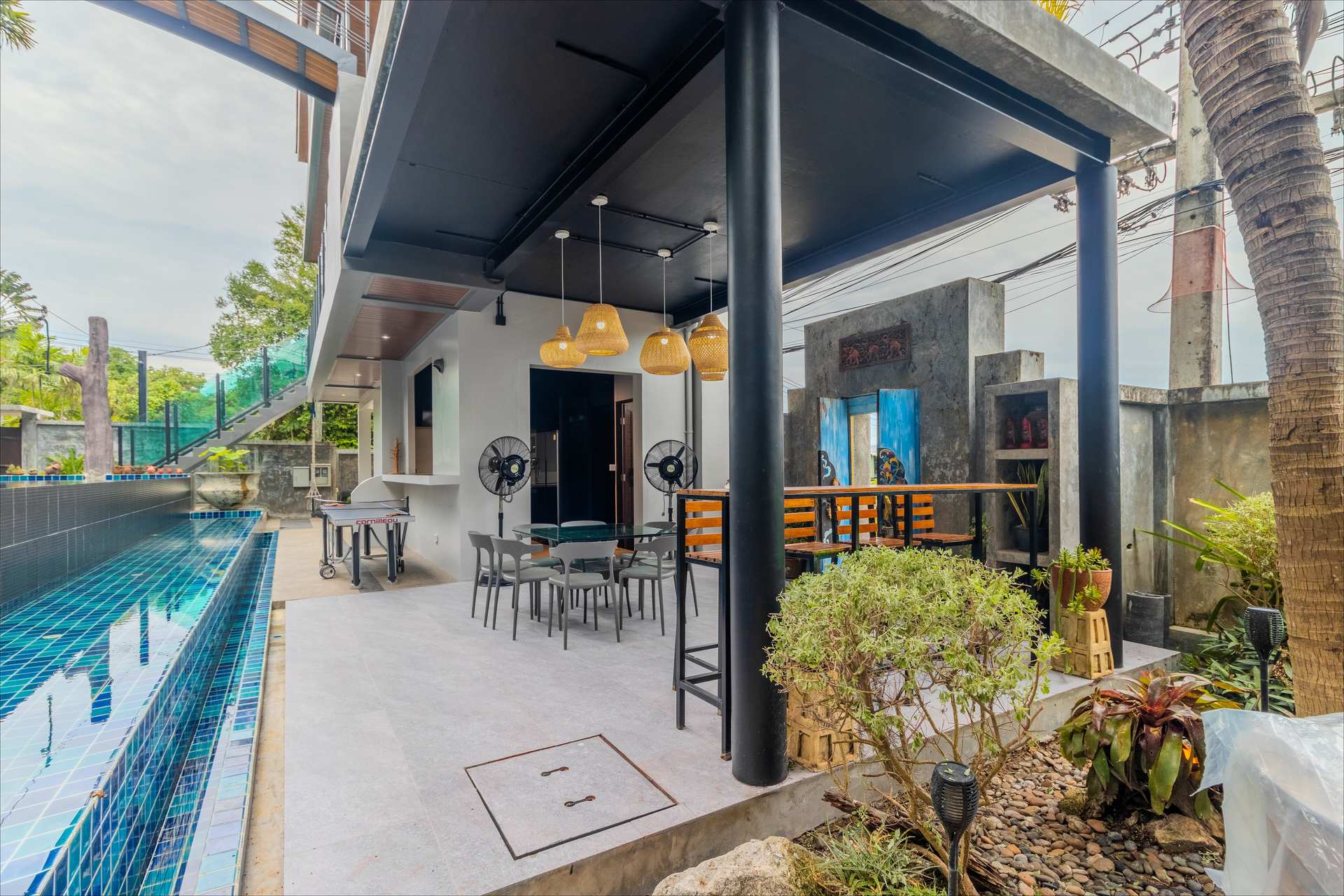 Outdoor barbecue and dining area with tropical garden backdrop at the Phuket villa