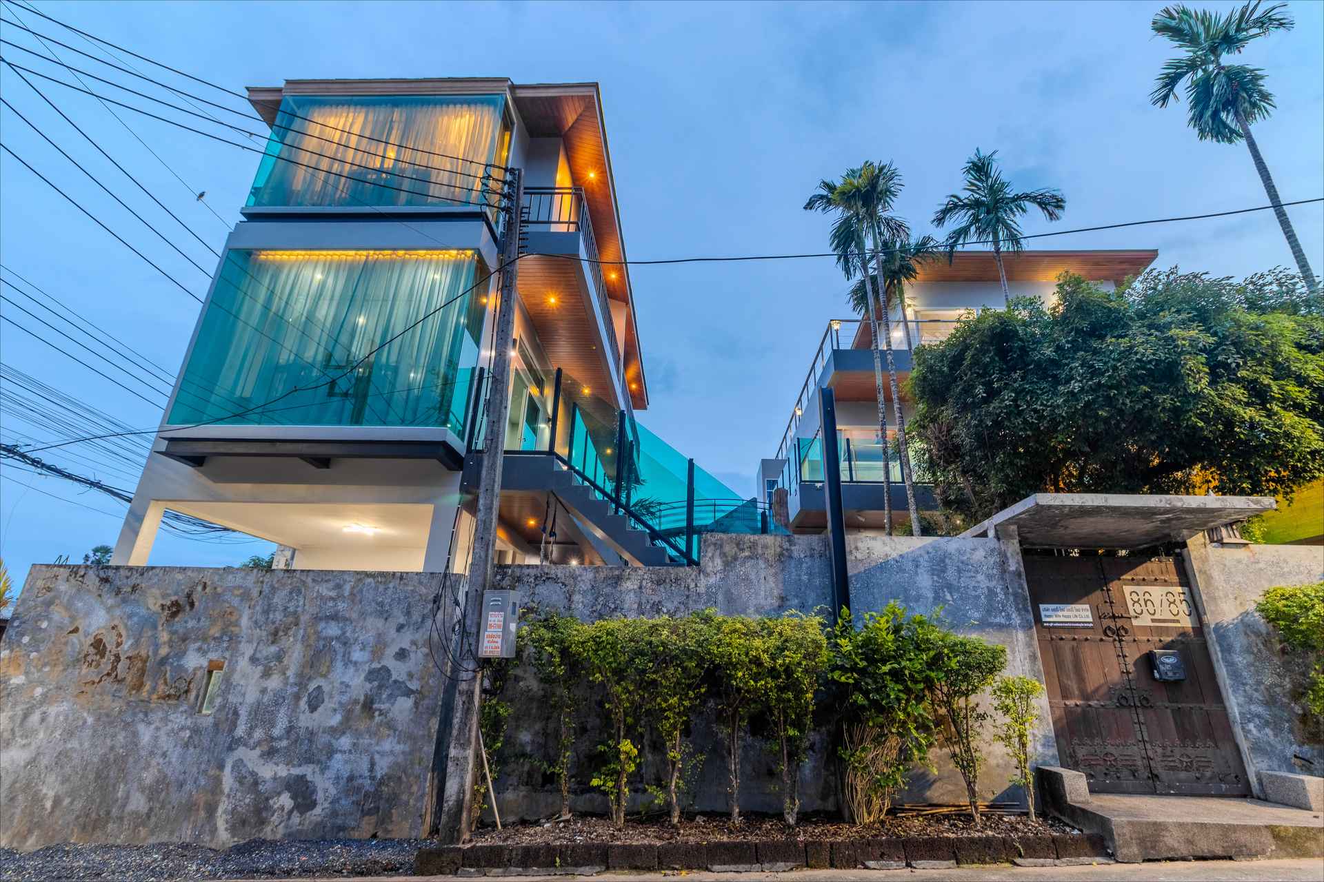 Aerial view of the entire villa estate with gardens and multiple pool areas in Rawai