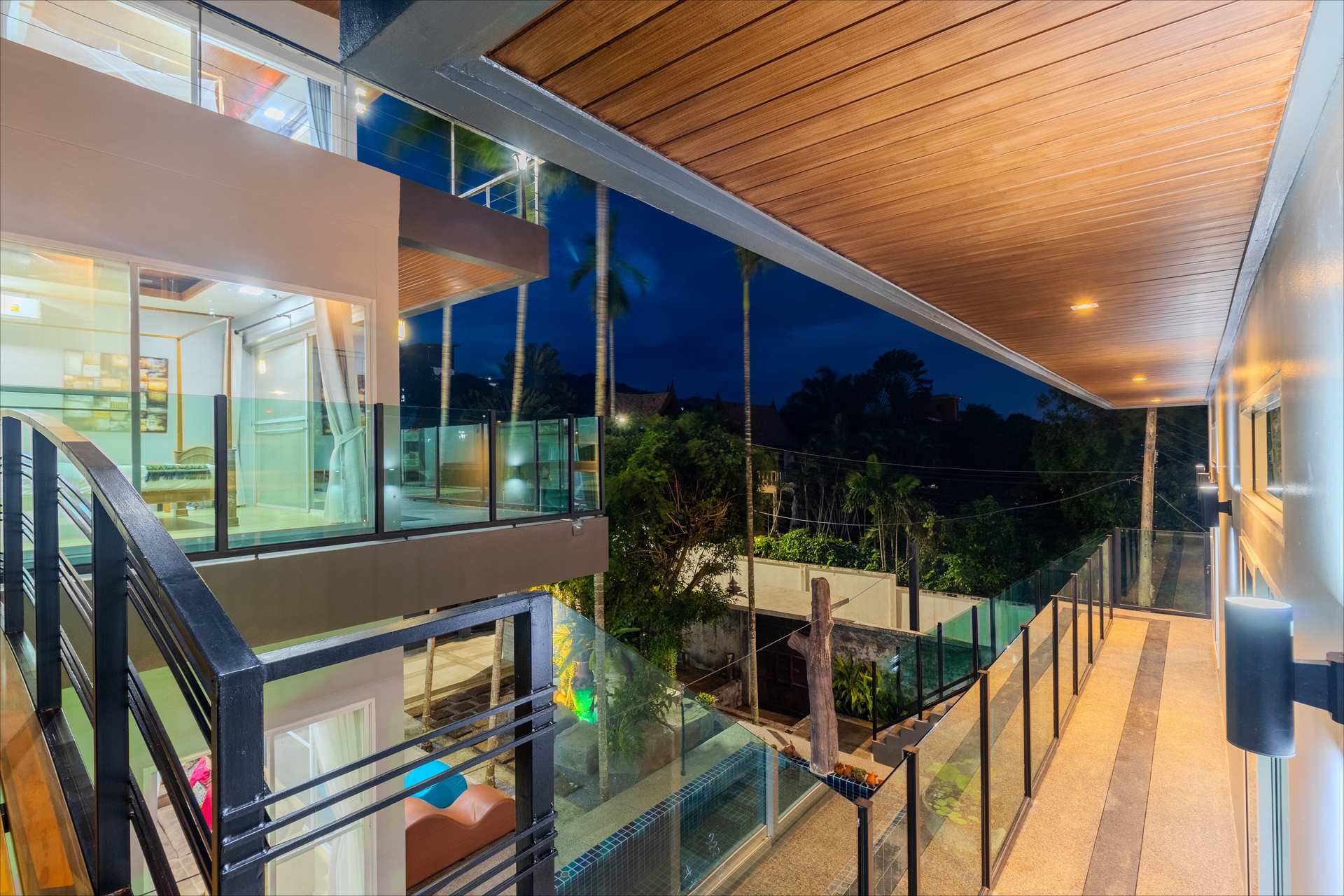 Outdoor ping pong table and kitchen pass-through bar with pool views at twilight